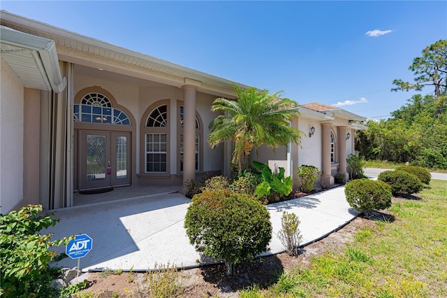 8315 Raoul Ave, North Port, FL 34291 - view of exterior entry with stucco siding and french doors