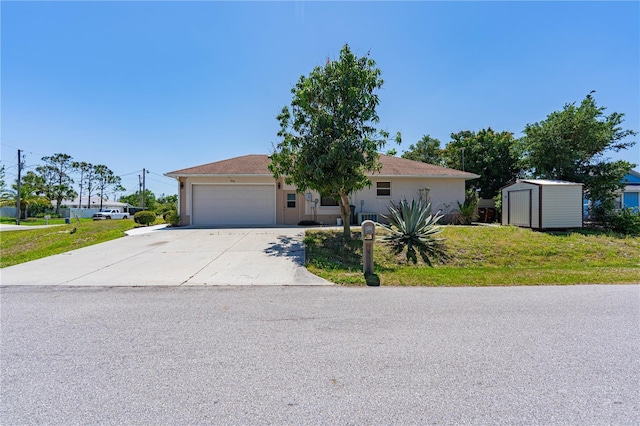 8315 Raoul Ave, North Port, FL 34291 - view of front of home with a storage shed, an attached garage, concrete driveway, an outbuilding, and a front yard
