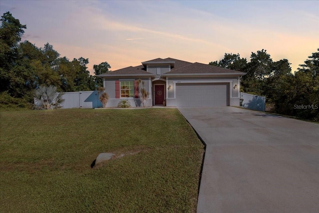 3476 Brewster Rd, North Port, FL 34288 - view of front facade with an attached garage, fence, a front lawn, a gate, and driveway