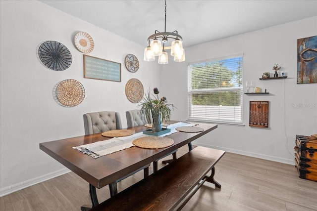 3476 Brewster Rd, North Port, FL 34288 - dining room featuring a chandelier, wood finished floors, and baseboards