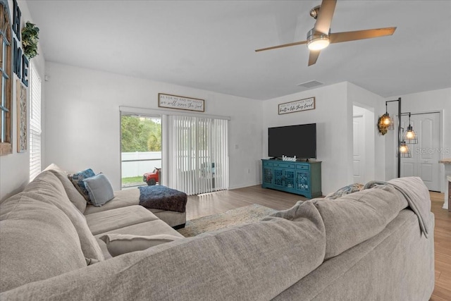 3476 Brewster Rd, North Port, FL 34288 - living room featuring wood finished floors, ceiling fan, and visible vents
