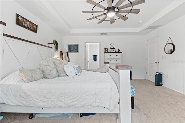 3476 Brewster Rd, North Port, FL 34288 - bedroom with carpet flooring, visible vents, a tray ceiling, and a ceiling fan
