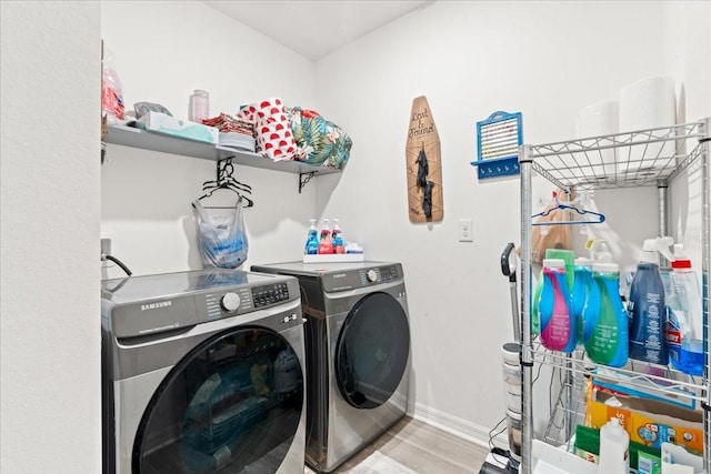 3476 Brewster Rd, North Port, FL 34288 - clothes washing area featuring washer and dryer, laundry area, baseboards, and wood finished floors