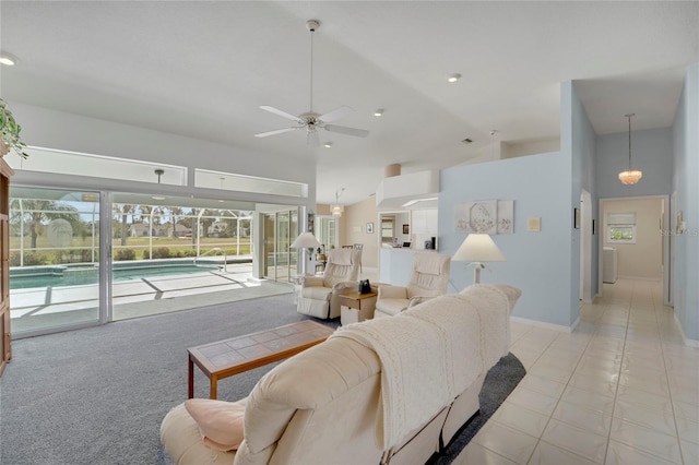 229 Sportsman Rd, Rotonda West, FL 33947 - living area featuring light tile patterned floors, baseboards, a ceiling fan, and high vaulted ceiling