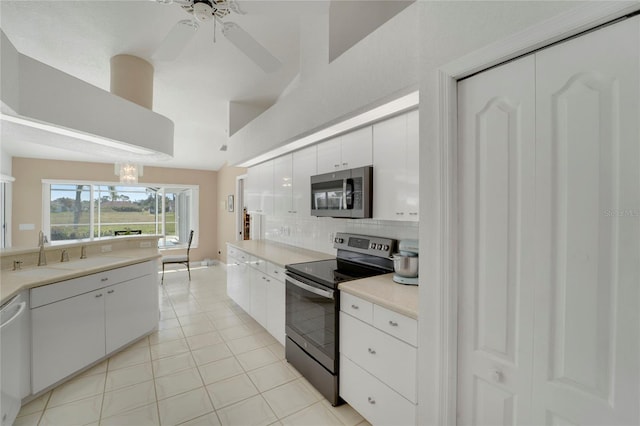229 Sportsman Rd, Rotonda West, FL 33947 - kitchen featuring tasteful backsplash, white cabinets, a sink, light countertops, and appliances with stainless steel finishes