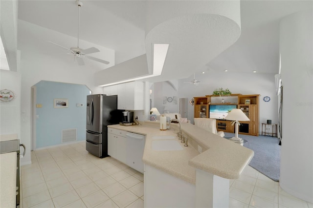 229 Sportsman Rd, Rotonda West, FL 33947 - kitchen with white dishwasher, a sink, a ceiling fan, a peninsula, and high vaulted ceiling