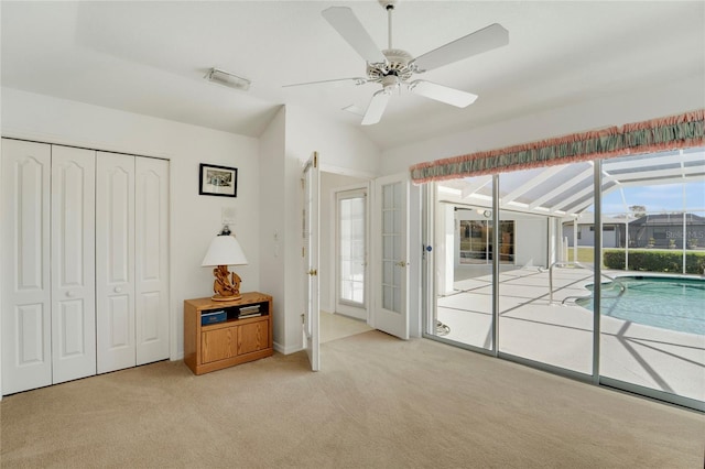 229 Sportsman Rd, Rotonda West, FL 33947 - unfurnished bedroom featuring access to outside, a closet, a ceiling fan, visible vents, and carpet flooring