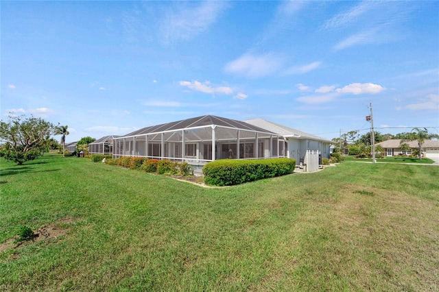 229 Sportsman Rd, Rotonda West, FL 33947 - rear view of house with a lawn and a lanai