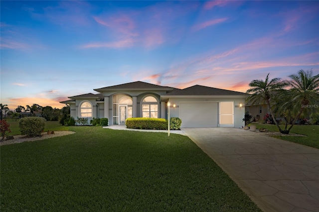 229 Sportsman Rd, Rotonda West, FL 33947 - view of front of home with stucco siding, a front lawn, a garage, and concrete driveway
