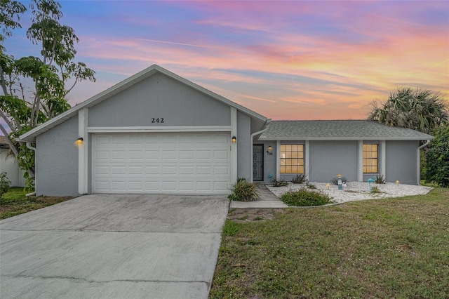 242 Seminole Blvd NW, Port Charlotte, FL 33952 - view of front of property with an attached garage, concrete driveway, stucco siding, and a front lawn