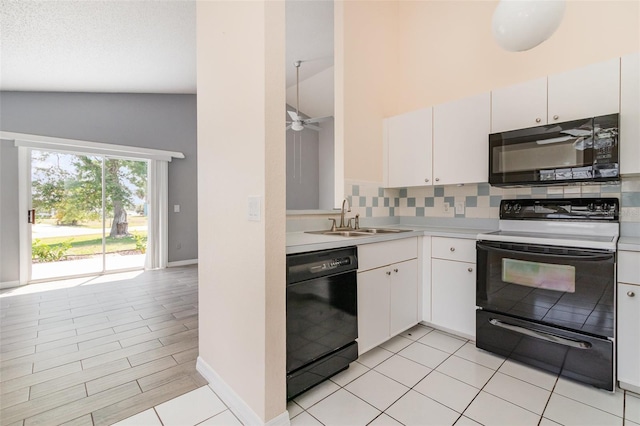 242 Seminole Blvd NW, Port Charlotte, FL 33952 - kitchen with tasteful backsplash, light countertops, white cabinets, black appliances, and a sink