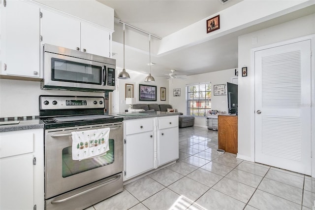 242 Seminole Blvd NW, Port Charlotte, FL 33952 - kitchen with open floor plan, white cabinets, ceiling fan, and stainless steel appliances