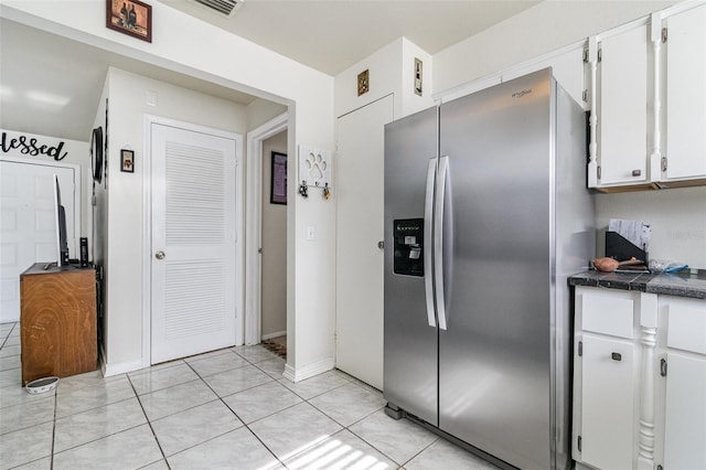 242 Seminole Blvd NW, Port Charlotte, FL 33952 - kitchen featuring light tile patterned floors, white cabinets, dark countertops, and stainless steel refrigerator with ice dispenser