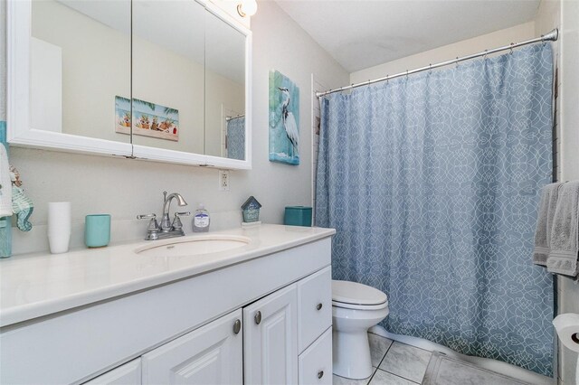 242 Seminole Blvd NW, Port Charlotte, FL 33952 - bathroom with tile patterned floors, toilet, a shower with shower curtain, and vanity