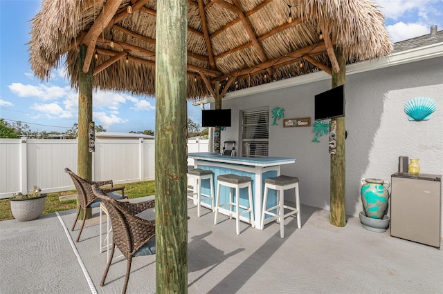 242 Seminole Blvd NW, Port Charlotte, FL 33952 - view of patio / terrace with outdoor dry bar and fence
