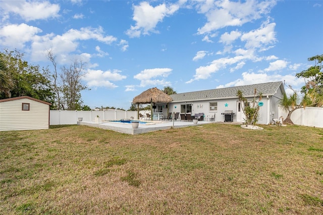 242 Seminole Blvd NW, Port Charlotte, FL 33952 - back of house with a fenced backyard, an outdoor structure, a lawn, a patio, and a gazebo