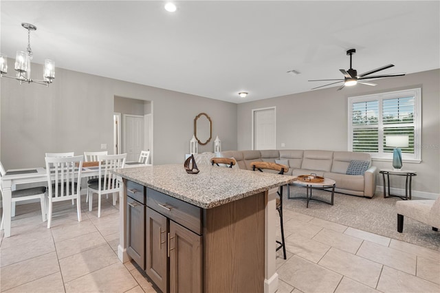 2229 Wakefield St, Port Charlotte, FL 33948 - kitchen featuring light tile patterned flooring, a breakfast bar area, a chandelier, and open floor plan