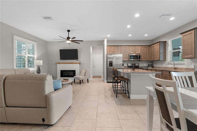 2229 Wakefield St, Port Charlotte, FL 33948 - living area with a ceiling fan, recessed lighting, a glass covered fireplace, and light tile patterned flooring
