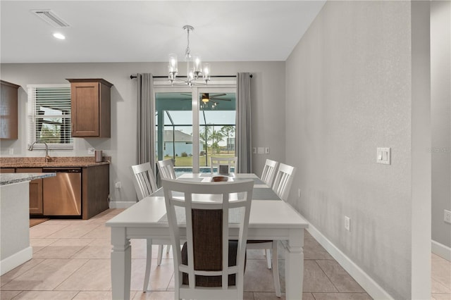 2229 Wakefield St, Port Charlotte, FL 33948 - dining area featuring a chandelier, baseboards, light tile patterned flooring, and a ceiling fan