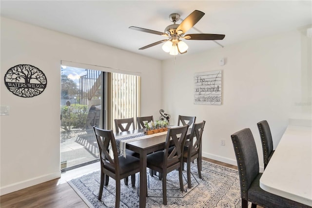 dining area with baseboards, ceiling fan, and wood finished floors