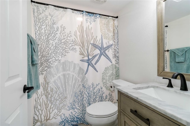 full bath with toilet and vanity