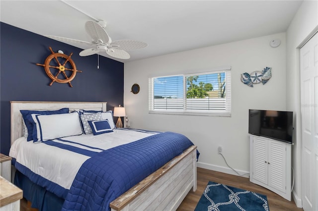 bedroom with baseboards, ceiling fan, and wood finished floors