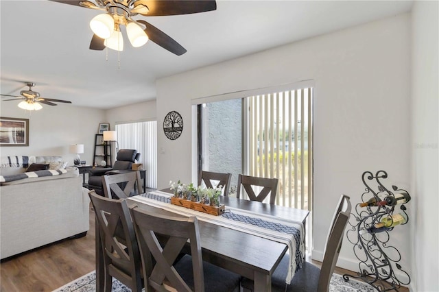 dining room featuring a ceiling fan and wood finished floors