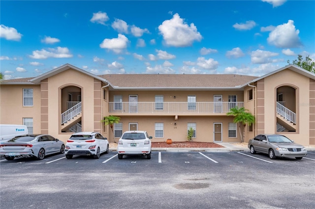 175 Kings Hwy Unit B21522, Punta Gorda, FL 33983 - view of property with uncovered parking and stairs