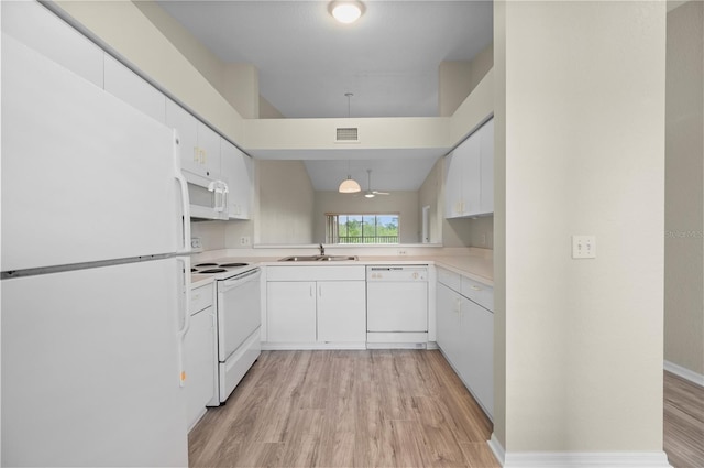 175 Kings Hwy Unit B21522, Punta Gorda, FL 33983 - kitchen featuring light wood-style floors, white appliances, visible vents, and a sink
