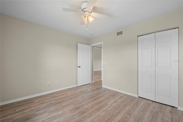 175 Kings Hwy Unit B21522, Punta Gorda, FL 33983 - unfurnished bedroom with a closet, baseboards, a ceiling fan, light wood-style floors, and visible vents