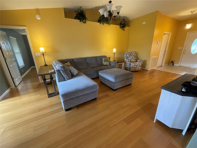1536 Willow Dl, Sebring, FL 33872 - living area with baseboards, vaulted ceiling, an inviting chandelier, light wood-style flooring, and visible vents