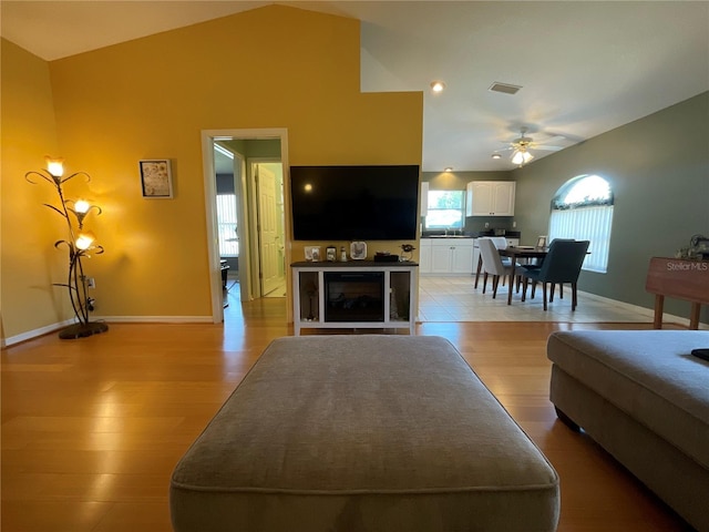 1536 Willow Dl, Sebring, FL 33872 - living area with baseboards, light wood-style flooring, visible vents, lofted ceiling, and ceiling fan