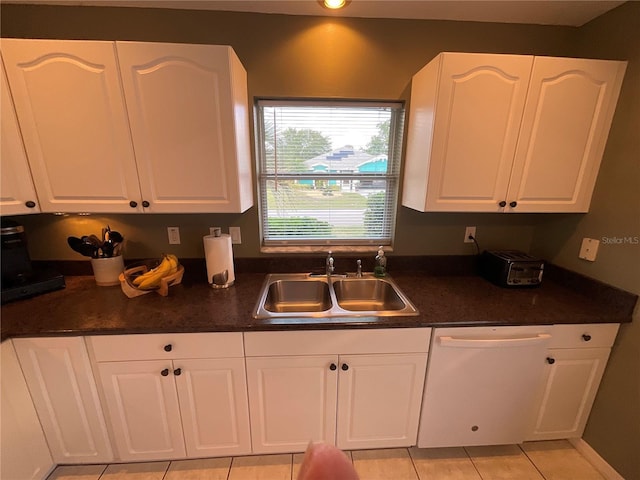 1536 Willow Dl, Sebring, FL 33872 - kitchen with white dishwasher, a sink, dark countertops, white cabinetry, and light tile patterned flooring