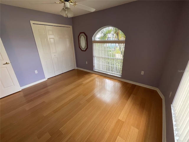 1536 Willow Dl, Sebring, FL 33872 - unfurnished bedroom with light wood-type flooring, a closet, ceiling fan, and baseboards