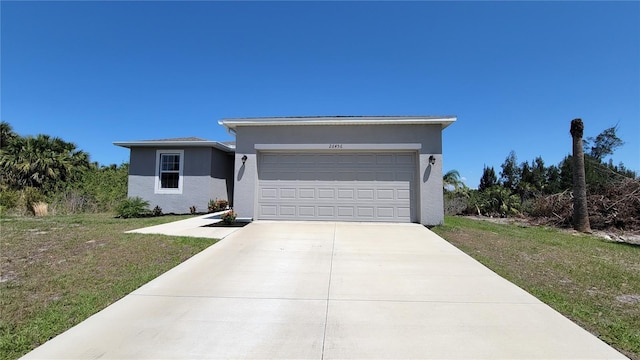 26456 View Dr, Punta Gorda, FL 33983 - view of front of house with a garage, stucco siding, driveway, and a front lawn