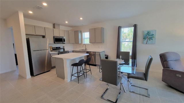 26456 View Dr, Punta Gorda, FL 33983 - kitchen with stainless steel appliances, gray cabinetry, a breakfast bar, and recessed lighting