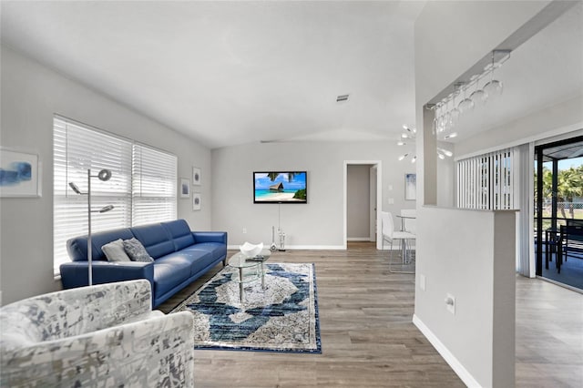 2621 Larkspur Dr, Punta Gorda, FL 33950 - living area with lofted ceiling, visible vents, baseboards, and wood finished floors