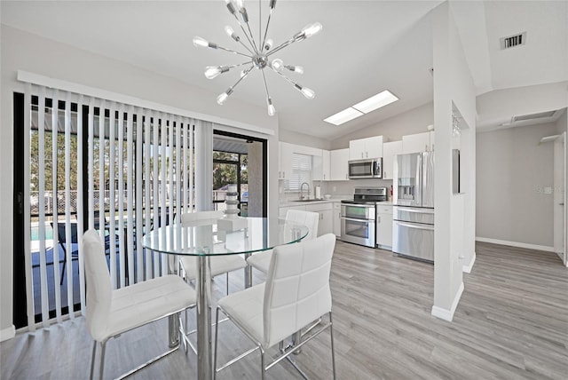 2621 Larkspur Dr, Punta Gorda, FL 33950 - dining area with light wood-style flooring, visible vents, vaulted ceiling, a notable chandelier, and baseboards