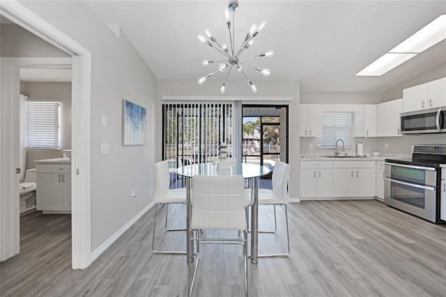 2621 Larkspur Dr, Punta Gorda, FL 33950 - dining space with light wood-style flooring, a notable chandelier, and baseboards