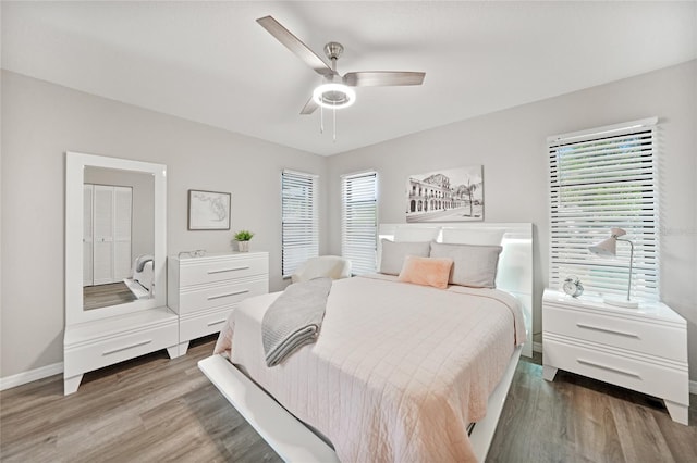 2621 Larkspur Dr, Punta Gorda, FL 33950 - bedroom featuring ceiling fan, multiple windows, baseboards, and wood finished floors