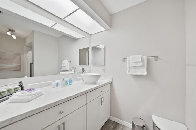2621 Larkspur Dr, Punta Gorda, FL 33950 - full bathroom featuring toilet, wood finished floors, vanity, and baseboards