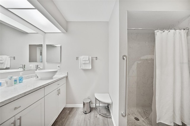 2621 Larkspur Dr, Punta Gorda, FL 33950 - bathroom featuring baseboards, tiled shower, vanity, and wood finished floors