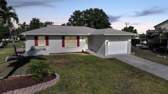 2621 Larkspur Dr, Punta Gorda, FL 33950 - ranch-style house featuring roof with shingles, stucco siding, driveway, an attached garage, and a front lawn