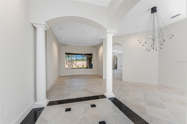 hall featuring arched walkways, visible vents, ornate columns, and baseboards