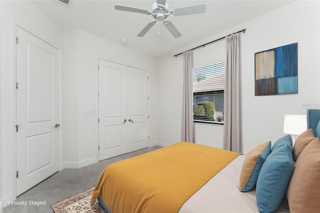 carpeted bedroom featuring a closet, baseboards, and a ceiling fan