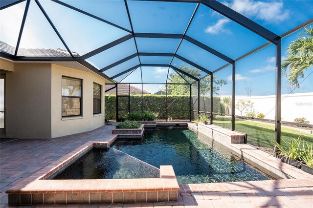 view of pool featuring a lanai, a patio area, and a fenced in pool