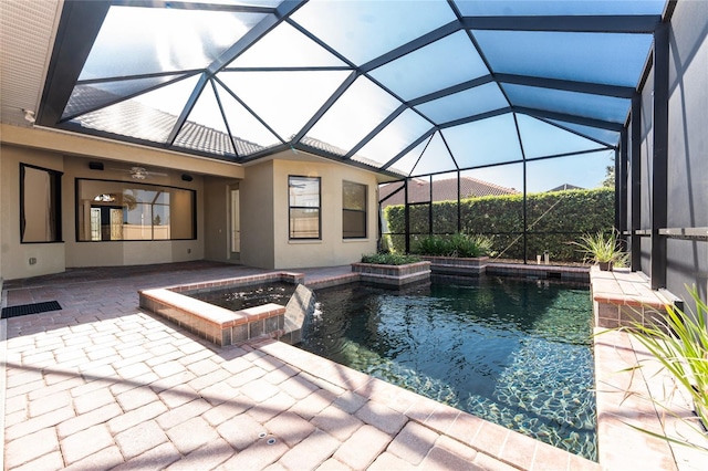 view of pool with a patio area, a pool with connected hot tub, and a lanai