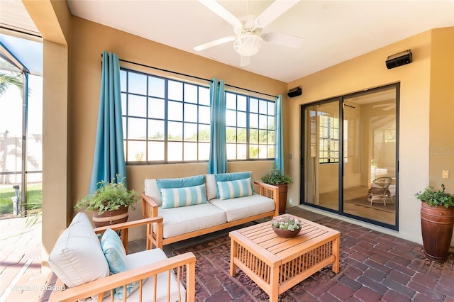 sunroom with outdoor lounge area and ceiling fan