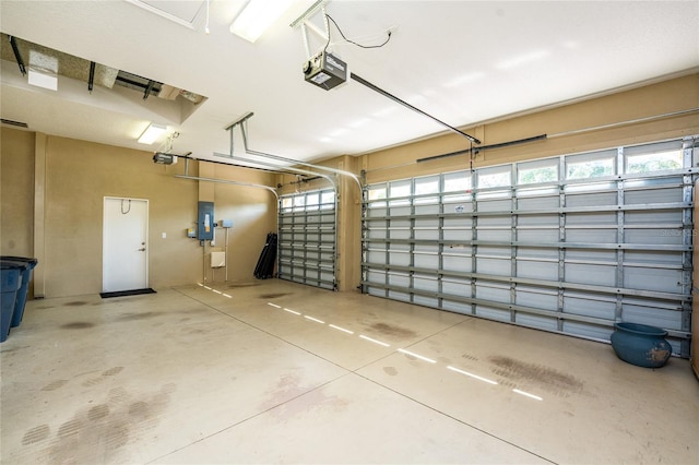 garage featuring a garage door opener and electric panel