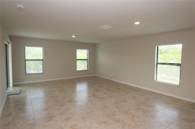spare room with recessed lighting, light tile patterned floors, and baseboards